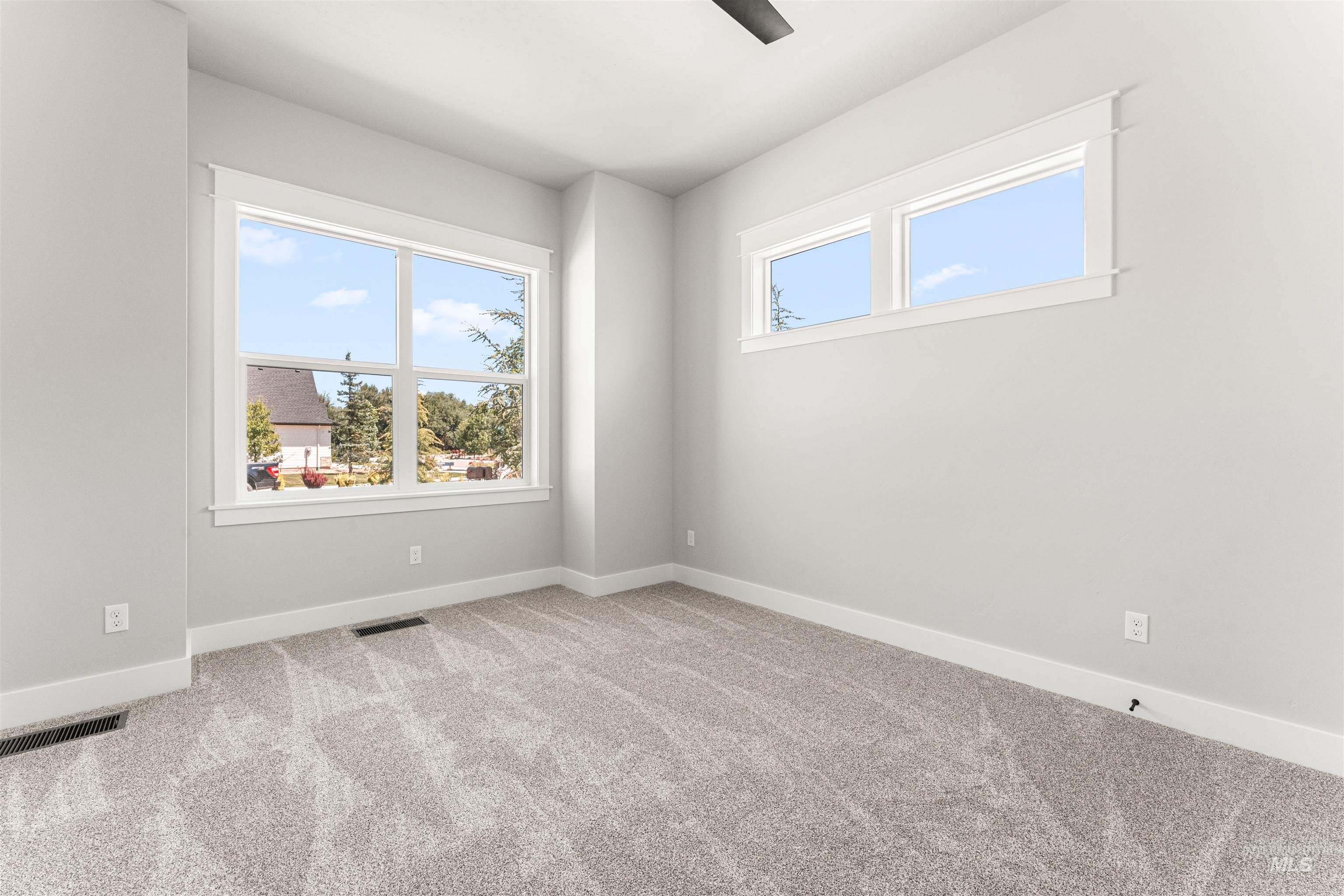 Carpeted empty room with baseboards