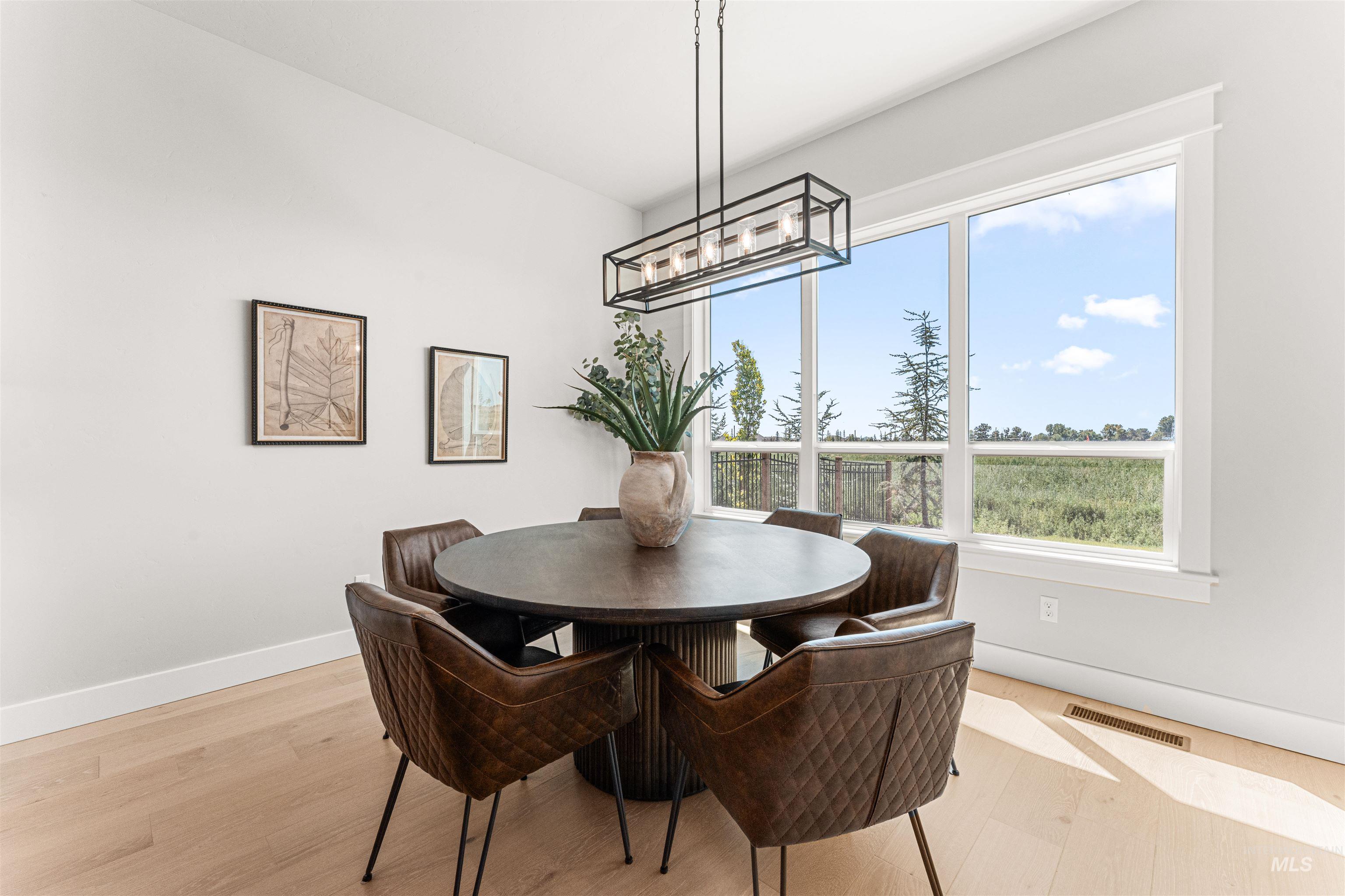 Dining room featuring light wood-style floors and a chandelier