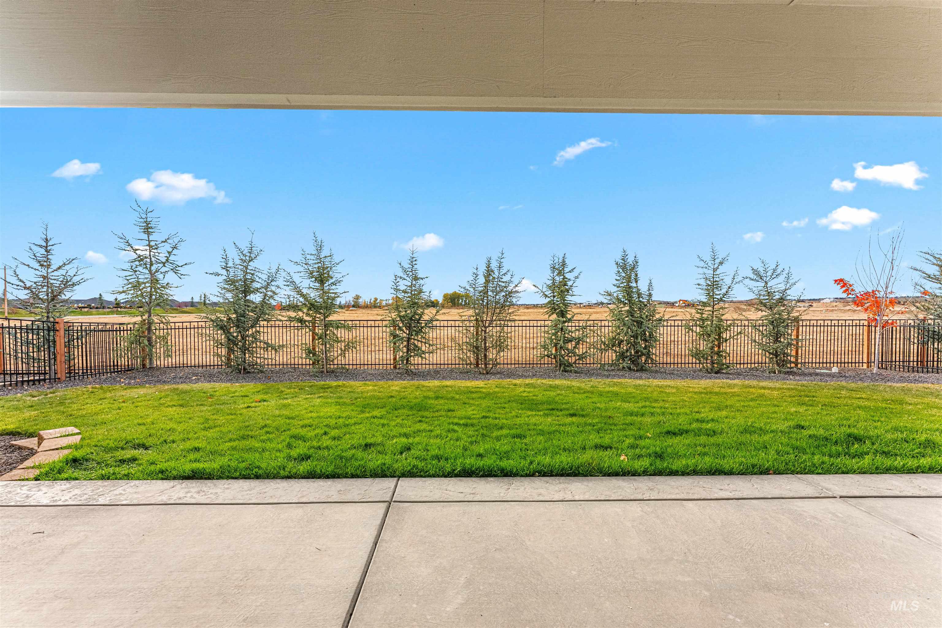 Fenced backyard with a patio area