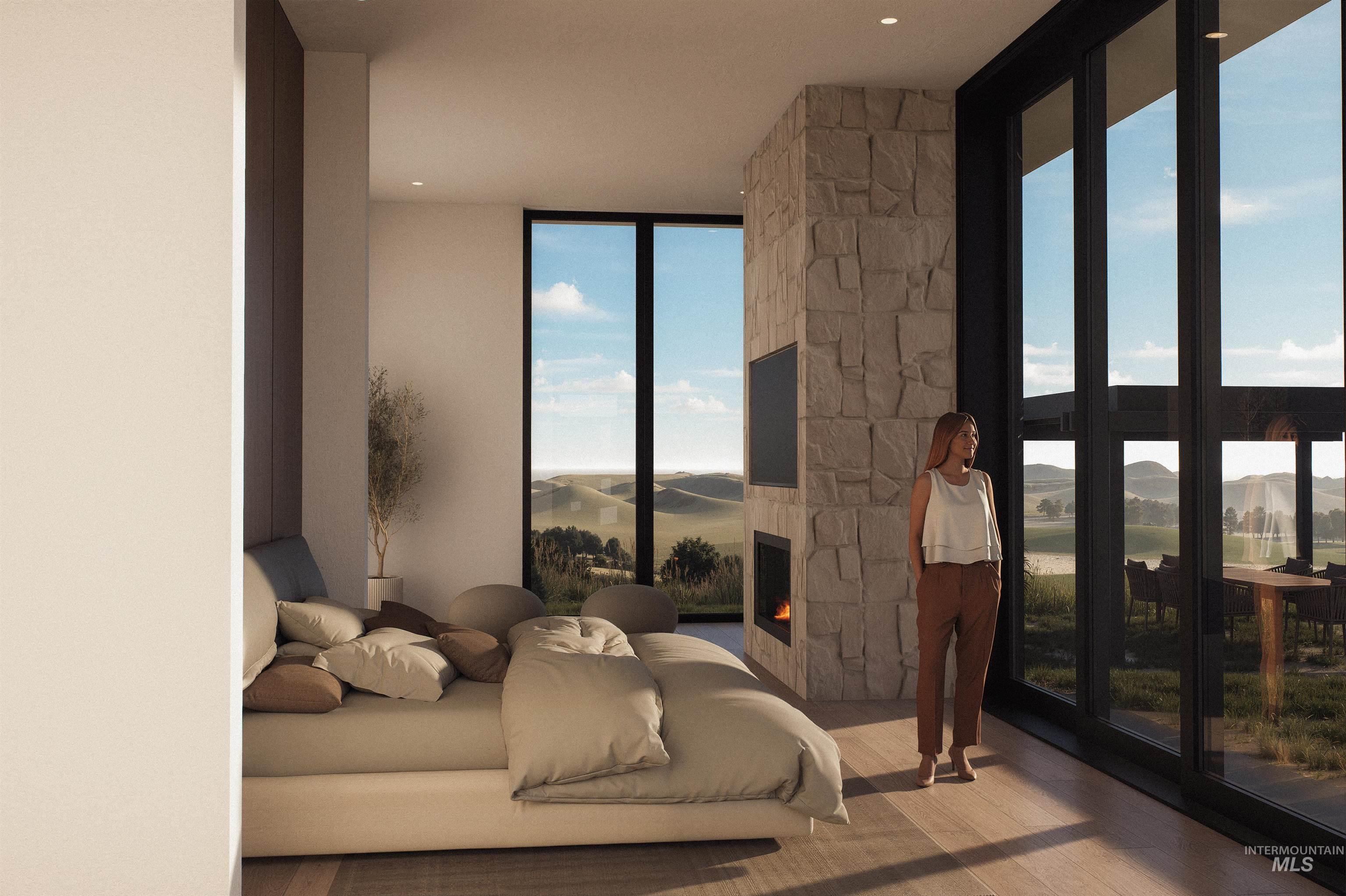 Interior room featuring wood-finish flooring, a stone-clad fireplace with an integrated television, and expansive floor-to-ceiling windows