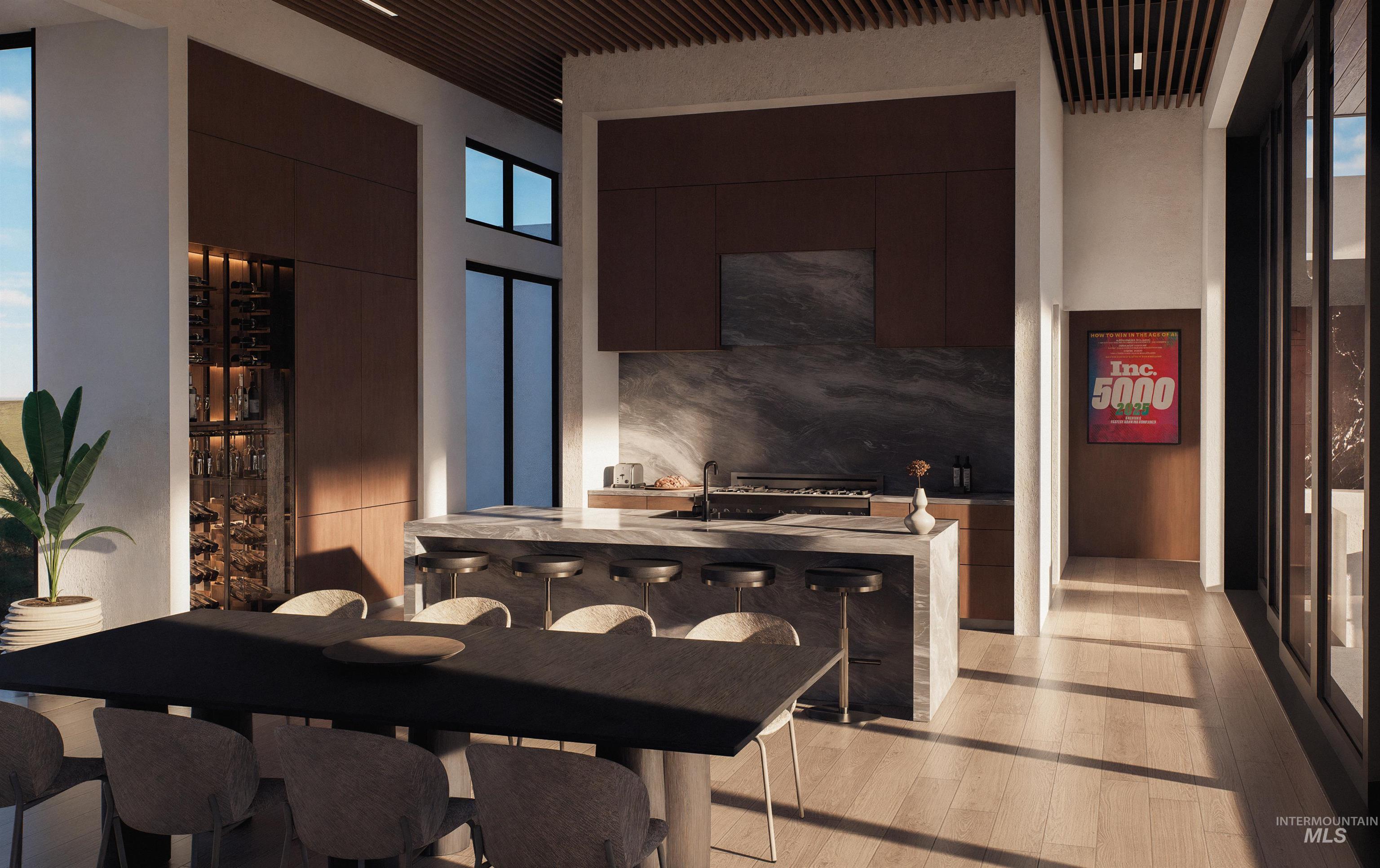 Dining space featuring light wood-type flooring and a high ceiling