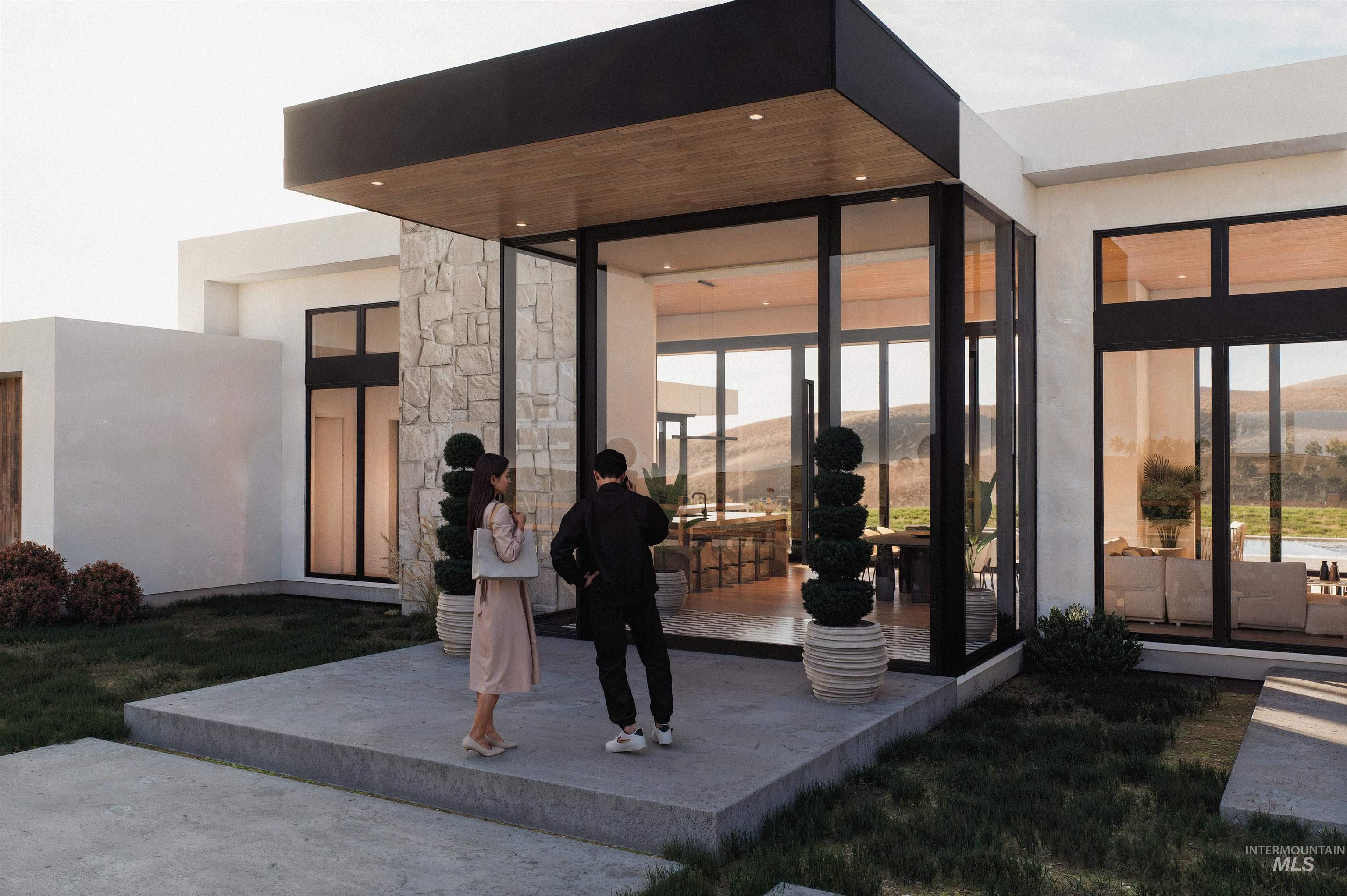 Property entrance with a patio area, stone siding, stucco siding, and a mountain view
