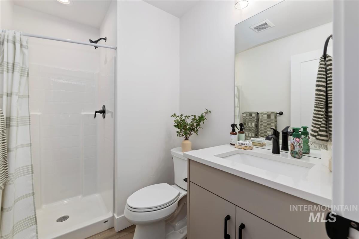 Bathroom featuring vanity and a stall shower