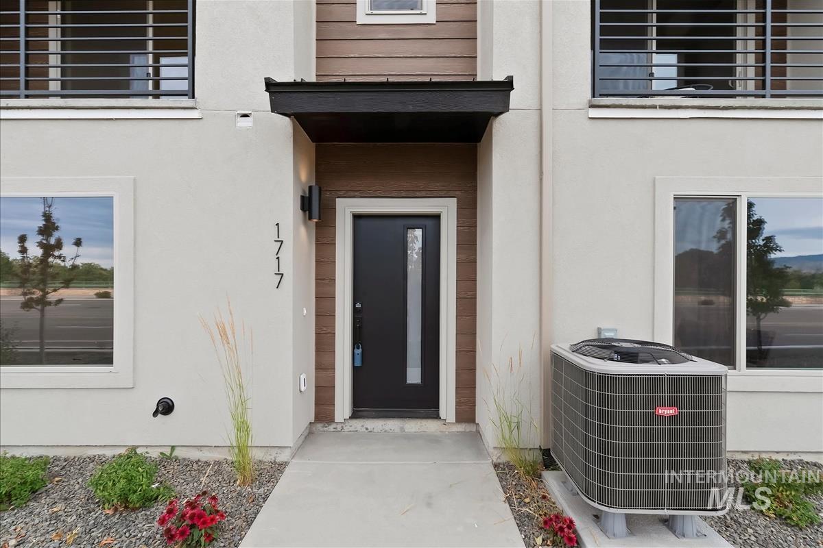 View of exterior entry featuring stucco siding