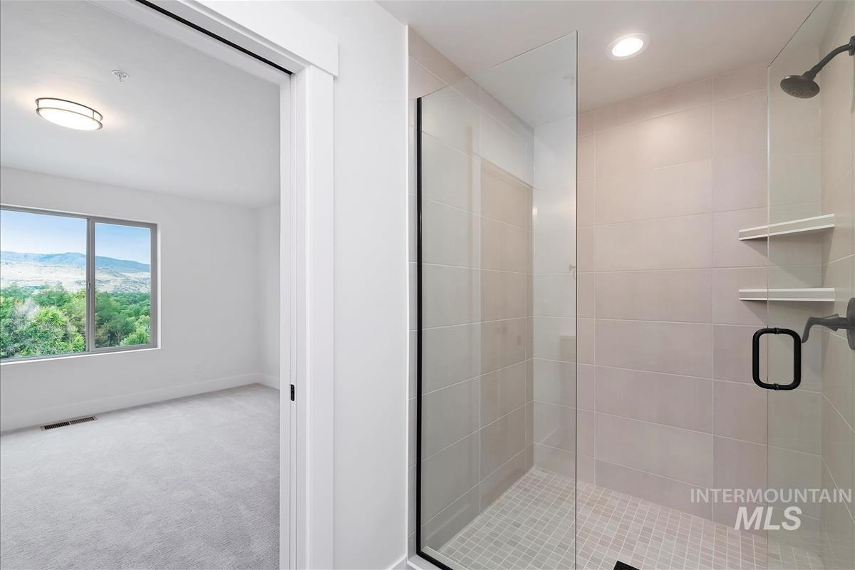 Bathroom with a stall shower, light carpet, a mountain view, and recessed lighting