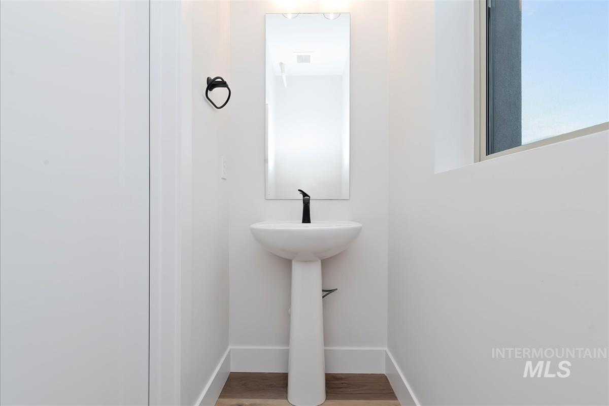 Bathroom featuring baseboards and light wood finished floors