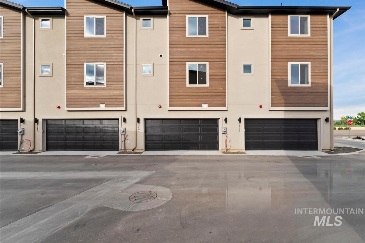 Back of property featuring a garage