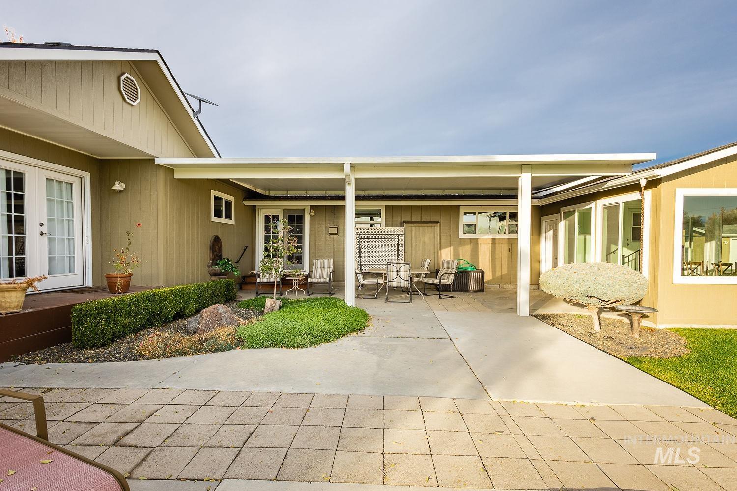 Back of house with french doors and a patio area