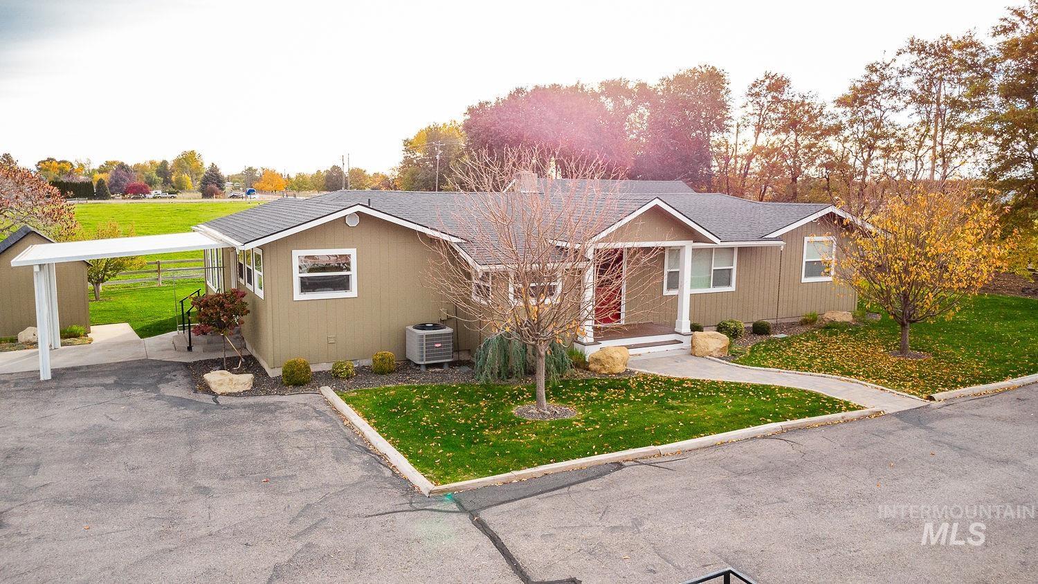 Ranch-style home featuring a front lawn