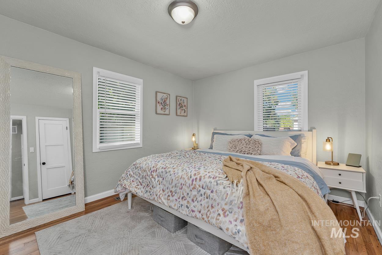 Bedroom featuring wood finished floors and a textured ceiling