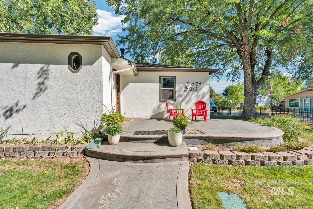 Property entrance with stucco siding and a patio area