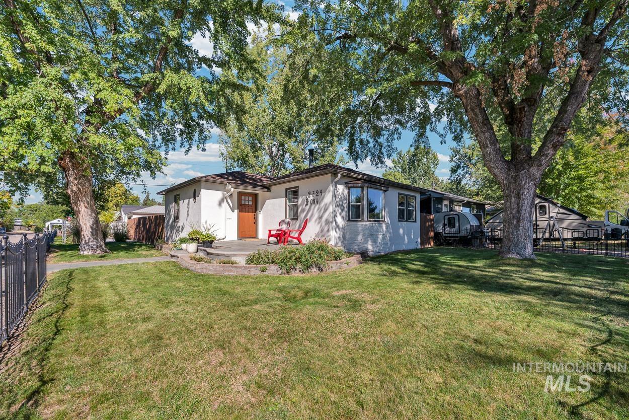 Ranch-style house featuring stucco siding