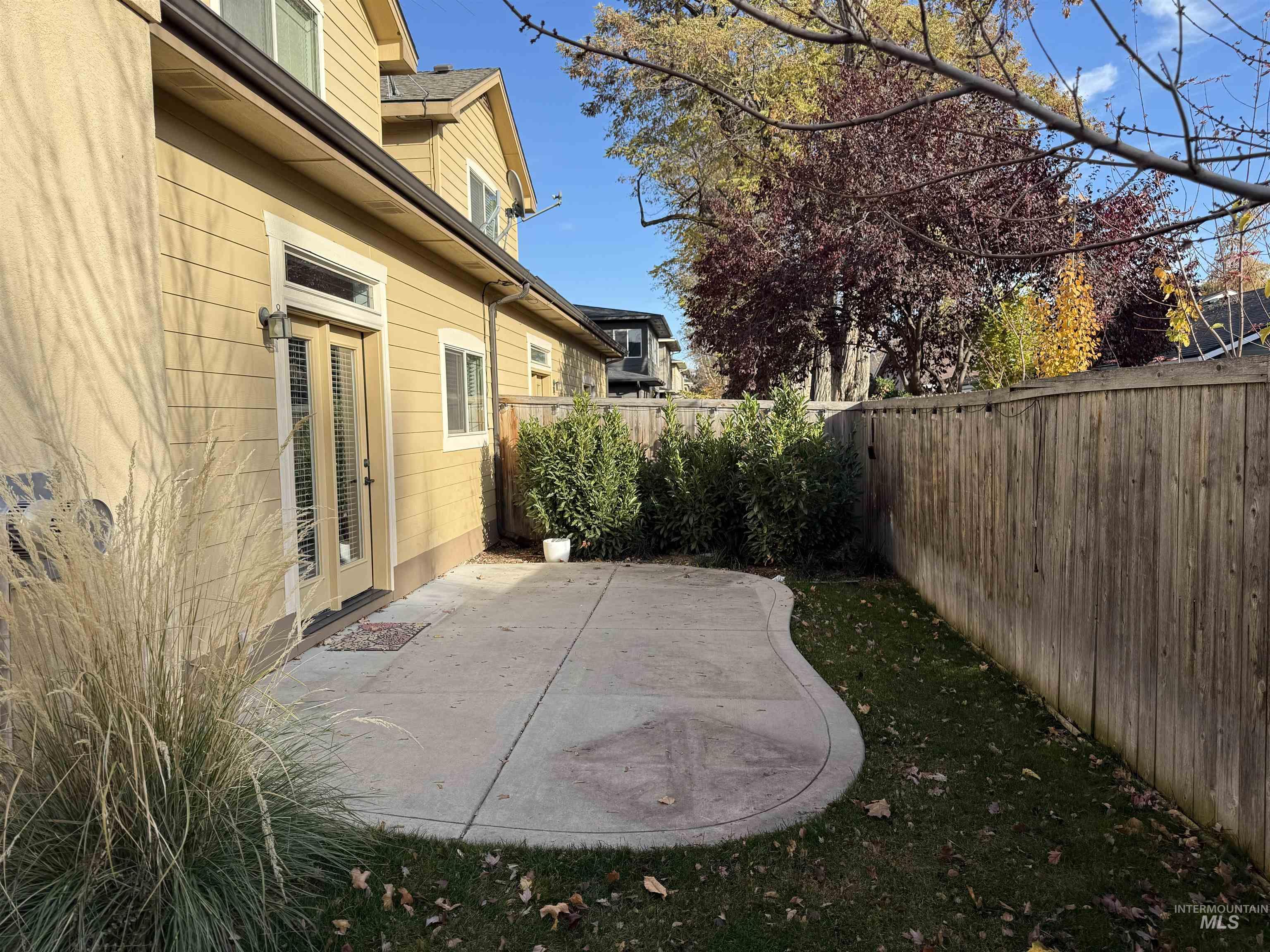 Fenced backyard featuring a patio and french doors