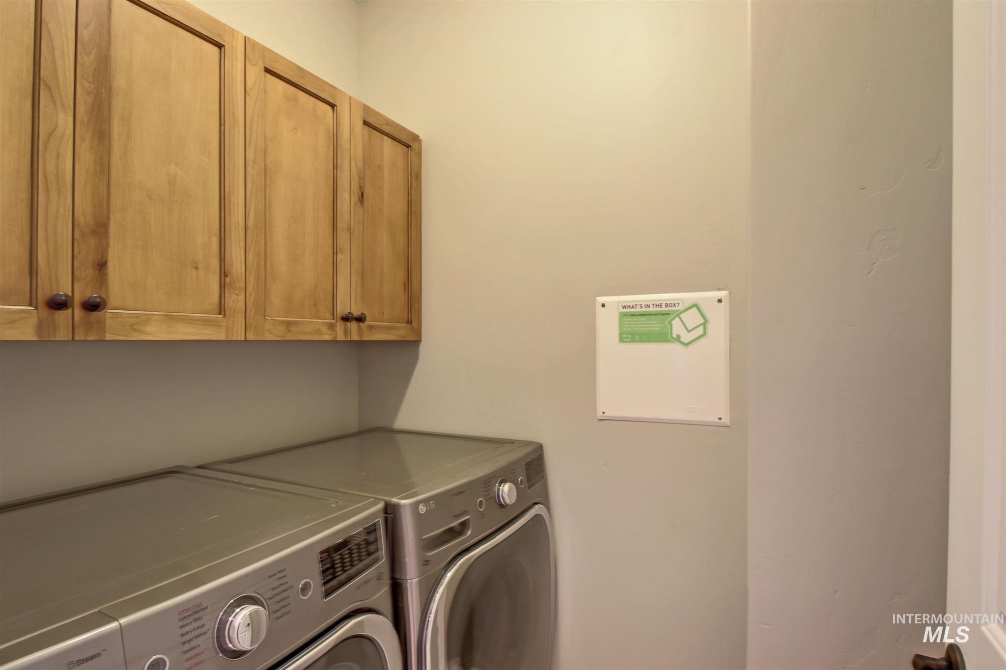 Laundry area featuring washing machine and dryer and cabinet space