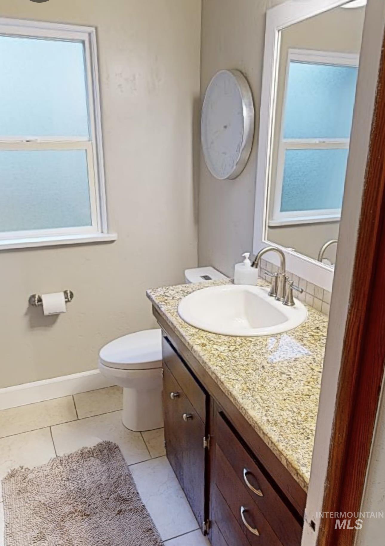 Bathroom with vanity and light tile patterned floors
