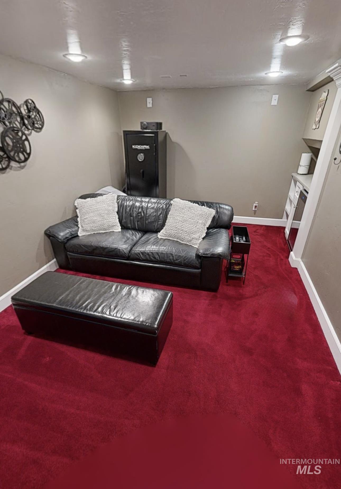 Carpeted living area with baseboards