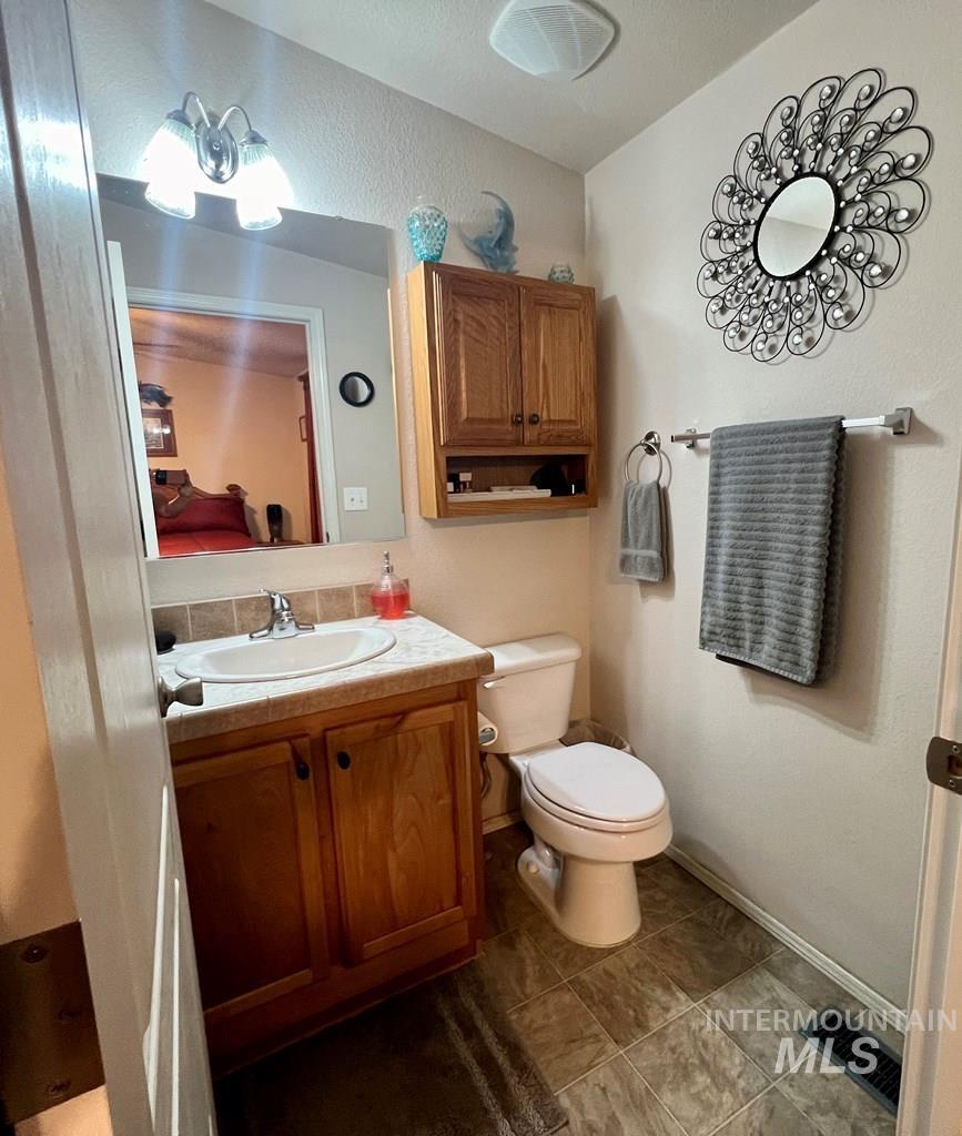 Ensuite bathroom with vanity and toilet