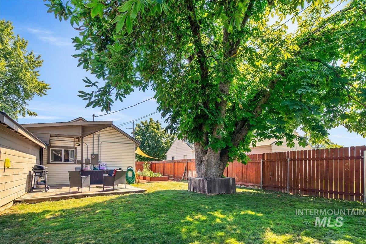 Fenced backyard with a deck