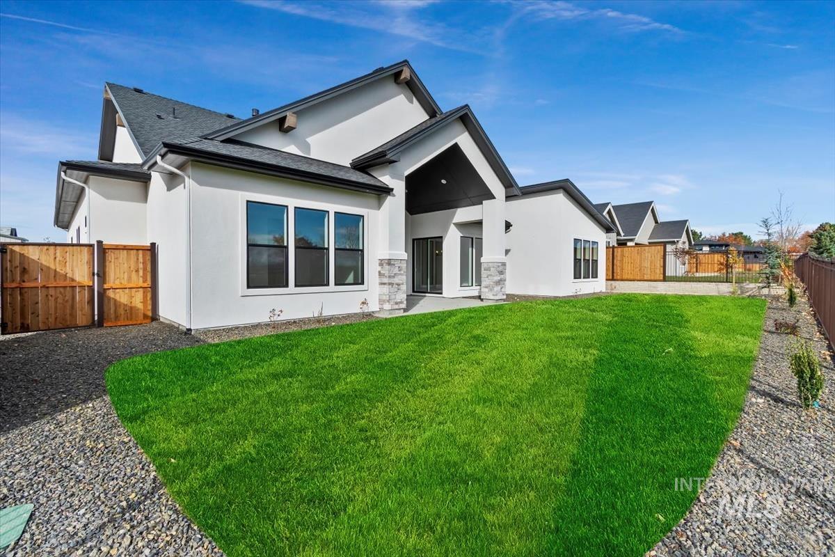 Back of house with a fenced backyard, a patio, stucco siding, and a shingled roof
