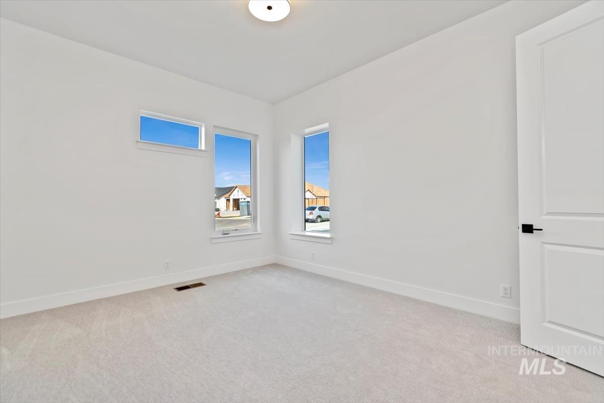 Unfurnished room with light colored carpet