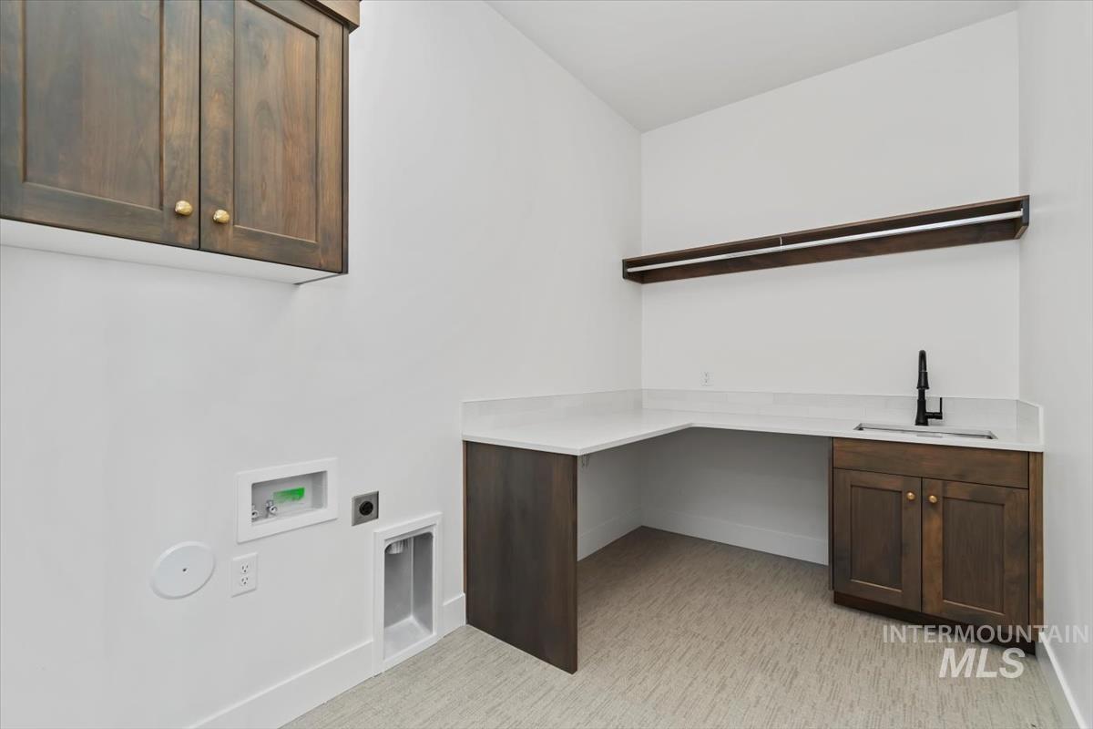 Laundry area featuring cabinet space, hookup for an electric dryer, and washer hookup