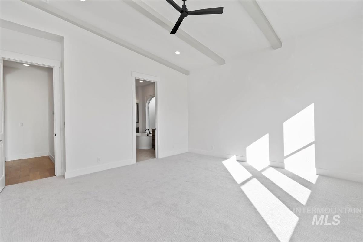 Unfurnished bedroom with light colored carpet, a ceiling fan, recessed lighting, and ensuite bathroom