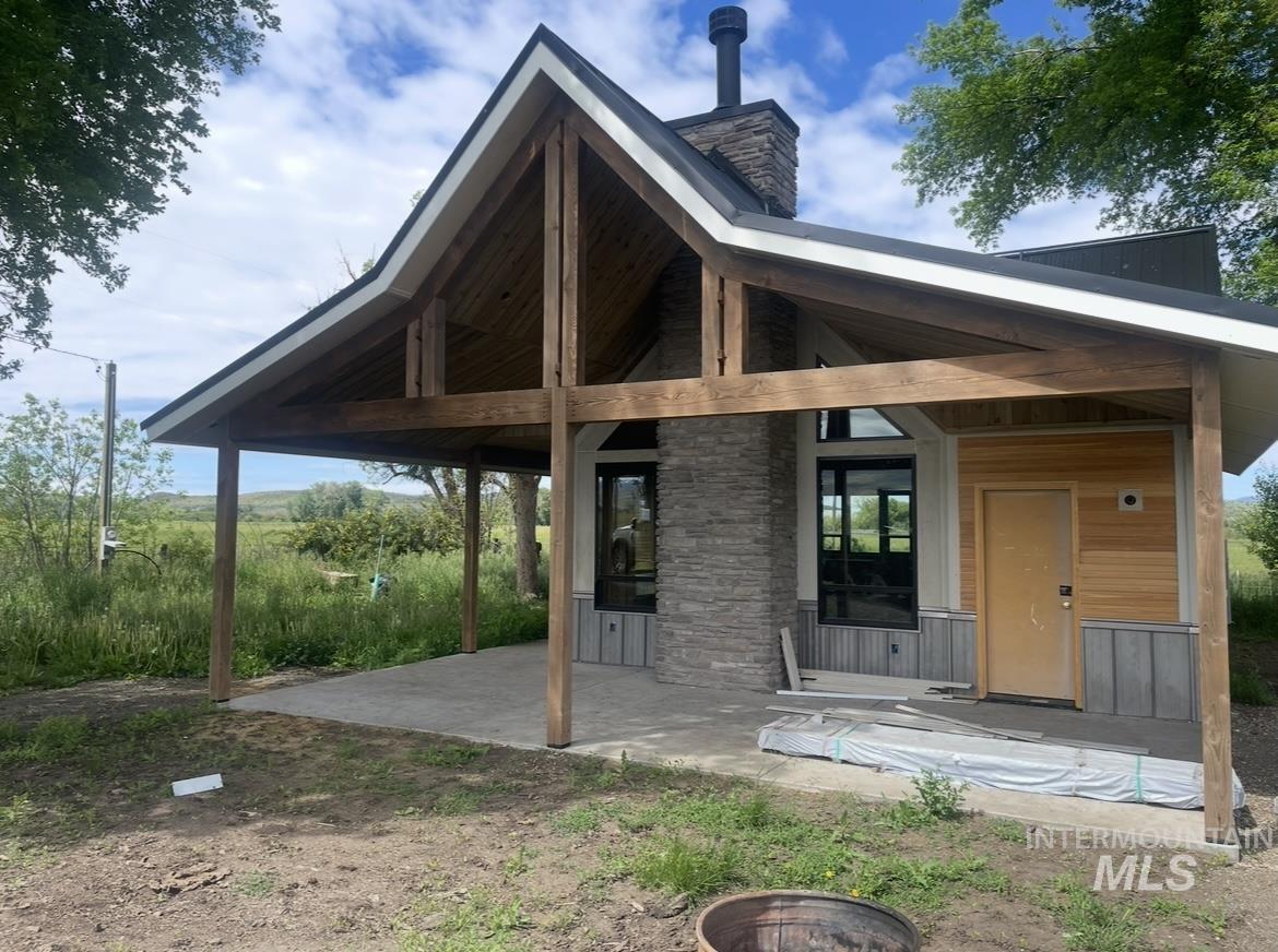 Back of property with a patio and a chimney