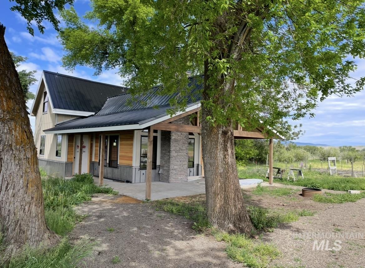 View of front facade with a metal roof and covered porch