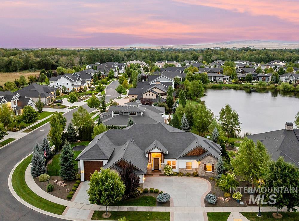 Aerial perspective of suburban area featuring a nearby body of water