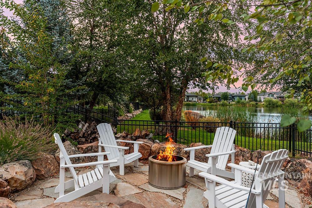 View of patio featuring a water view and a fire pit