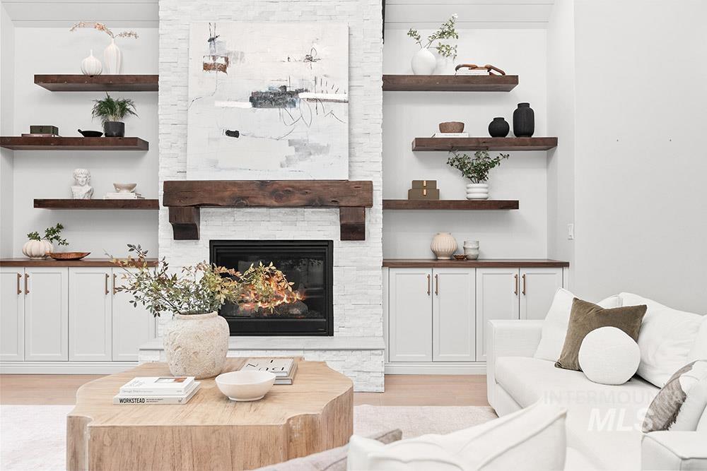 Living area with a fireplace and light wood-style floors