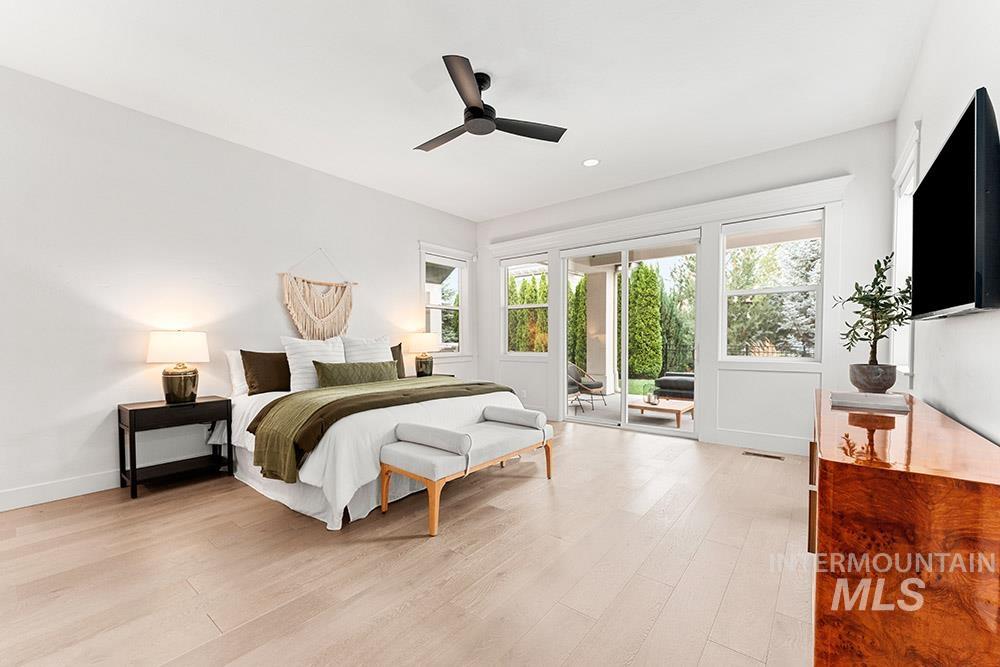 Bedroom with light wood-style floors, access to outside, multiple windows, ceiling fan, and recessed lighting