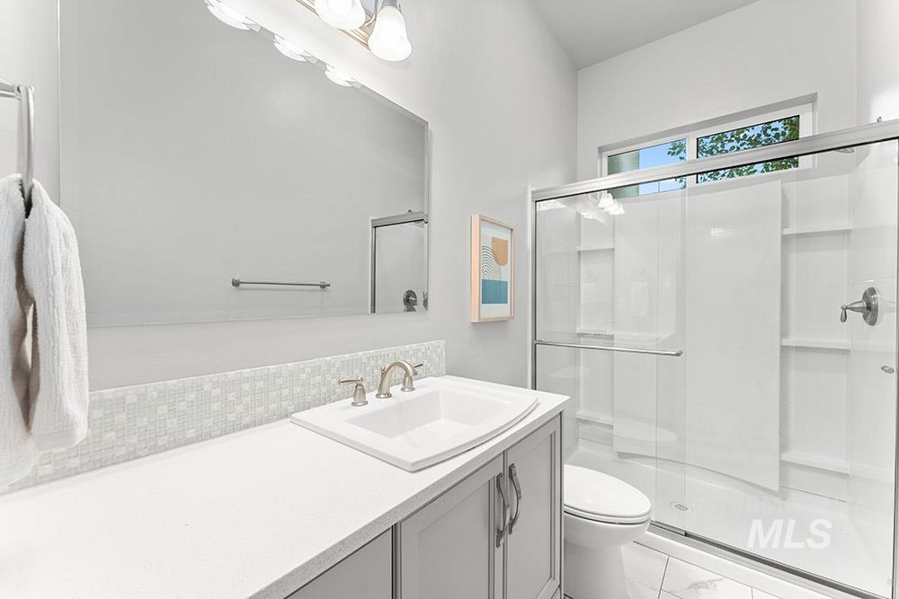 Bathroom with a stall shower and vanity