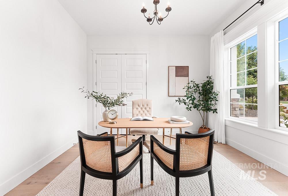 Dining space with a chandelier and light wood-type flooring