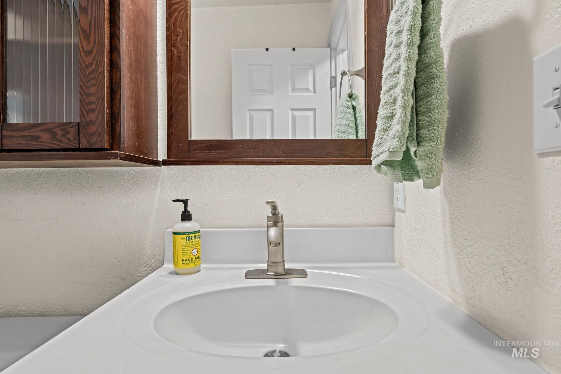 Bathroom featuring vanity and a textured wall