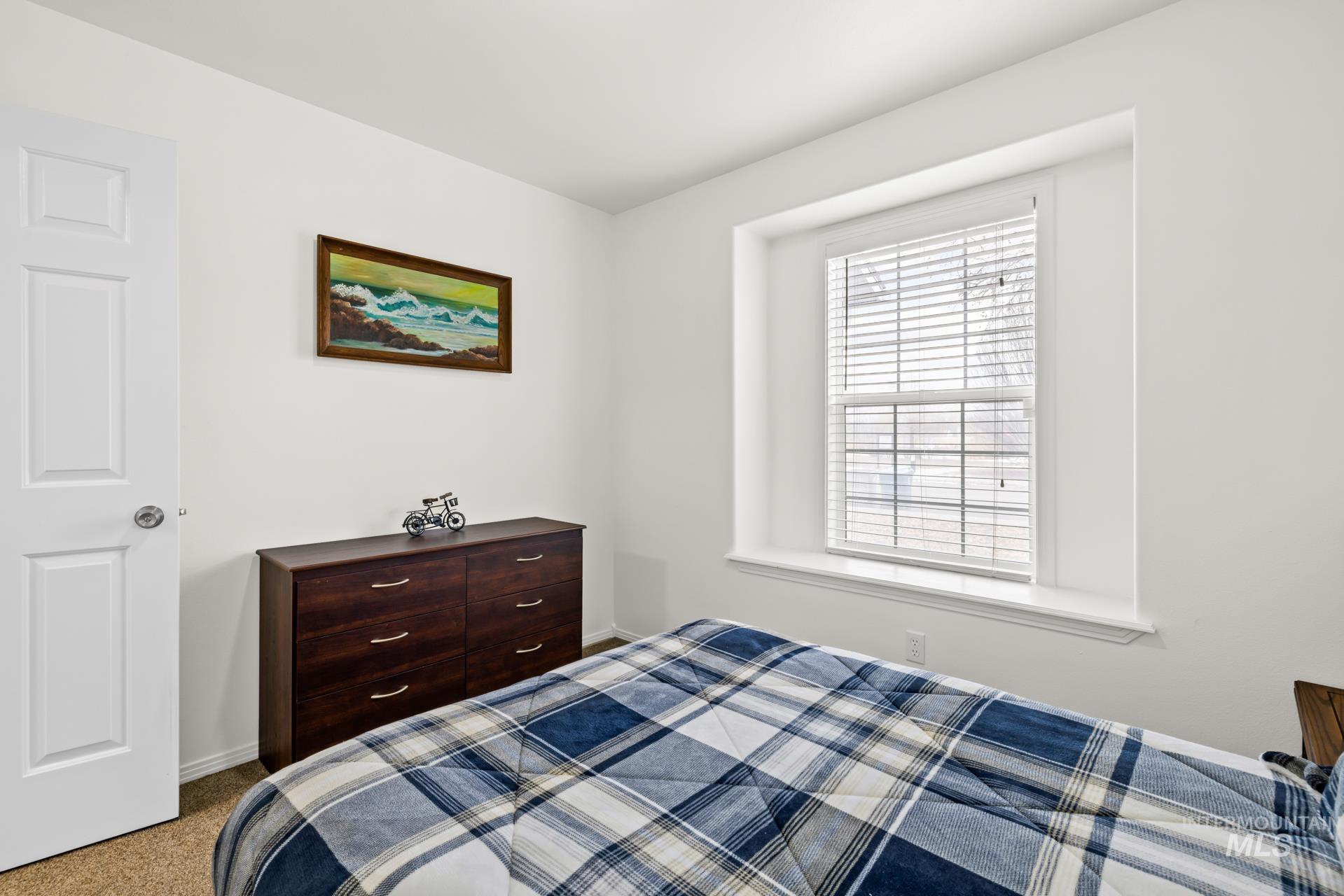 Carpeted bedroom with baseboards