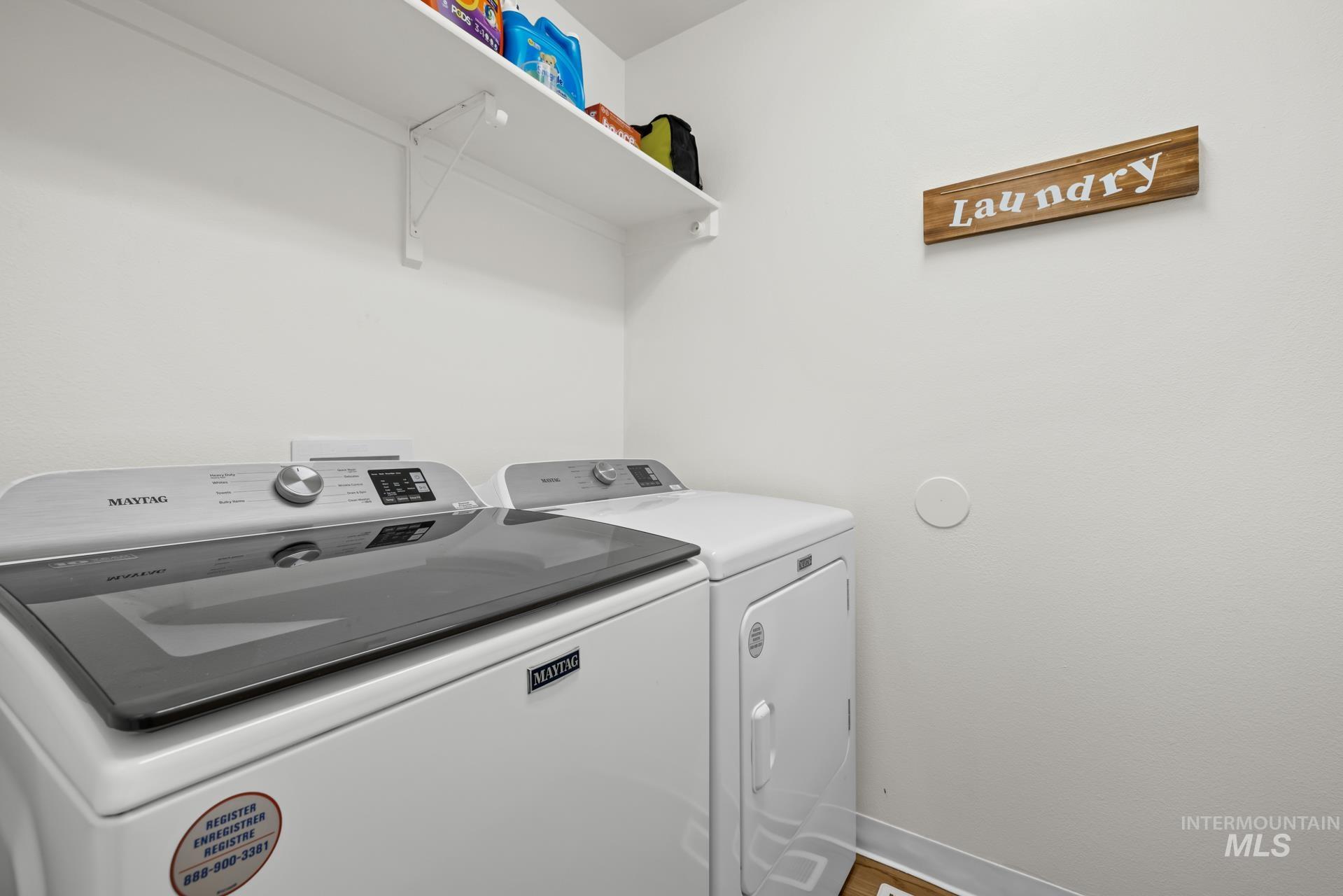 Laundry area with washing machine and dryer and baseboards