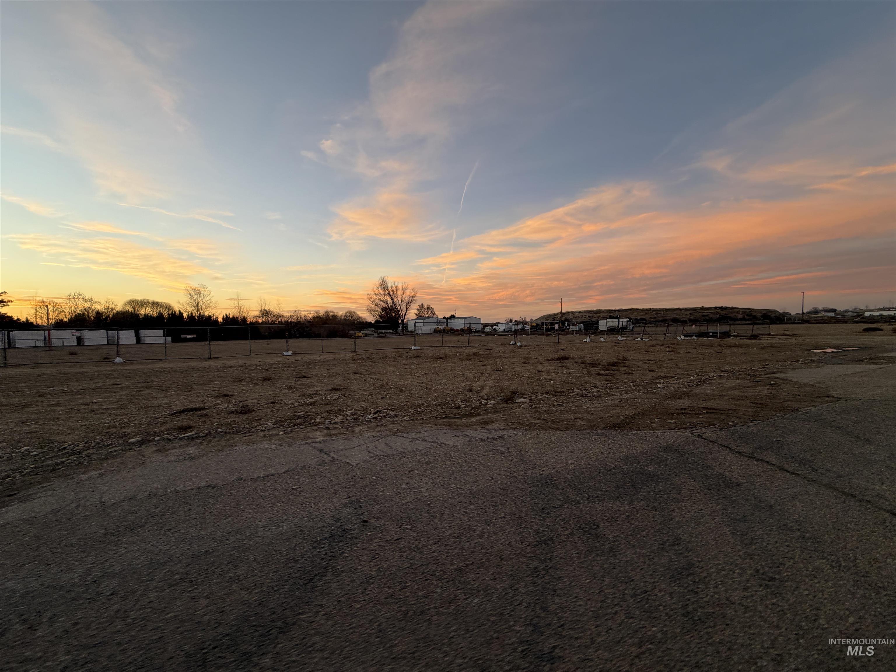 Yard at dusk featuring a view of countryside