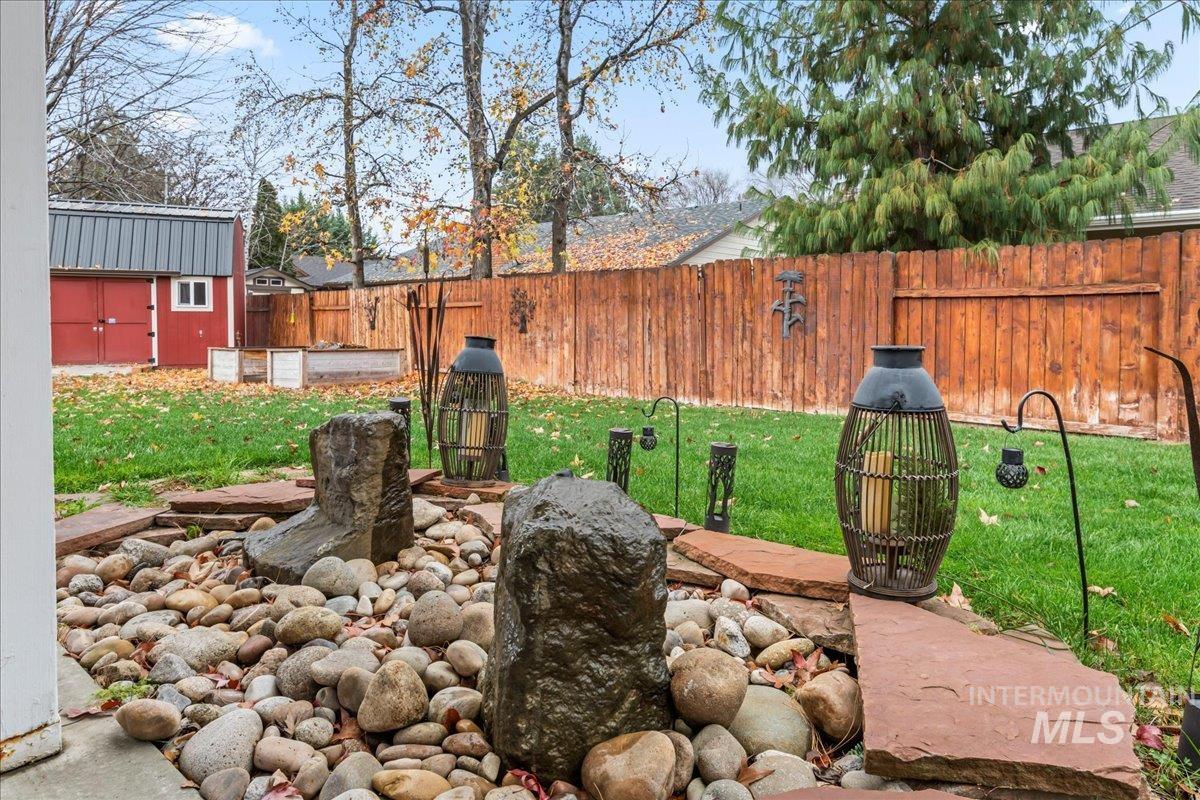Fenced backyard with a shed
