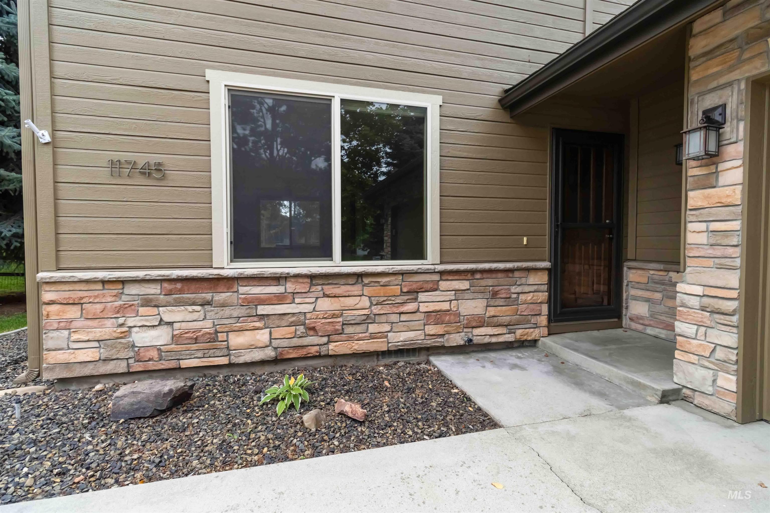 Property entrance featuring stone siding