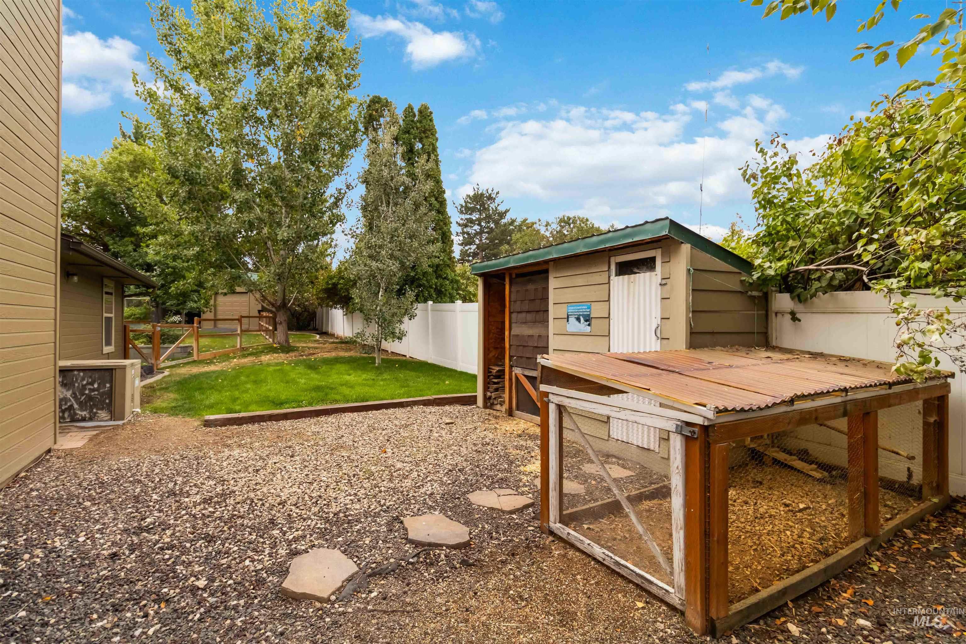 Fenced backyard with an outdoor structure and exterior structure