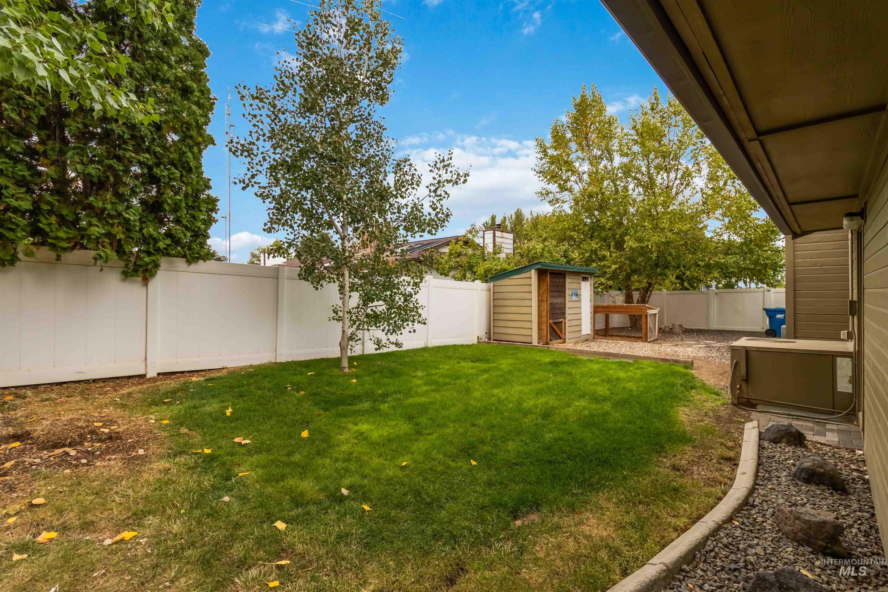 Fenced backyard with a shed