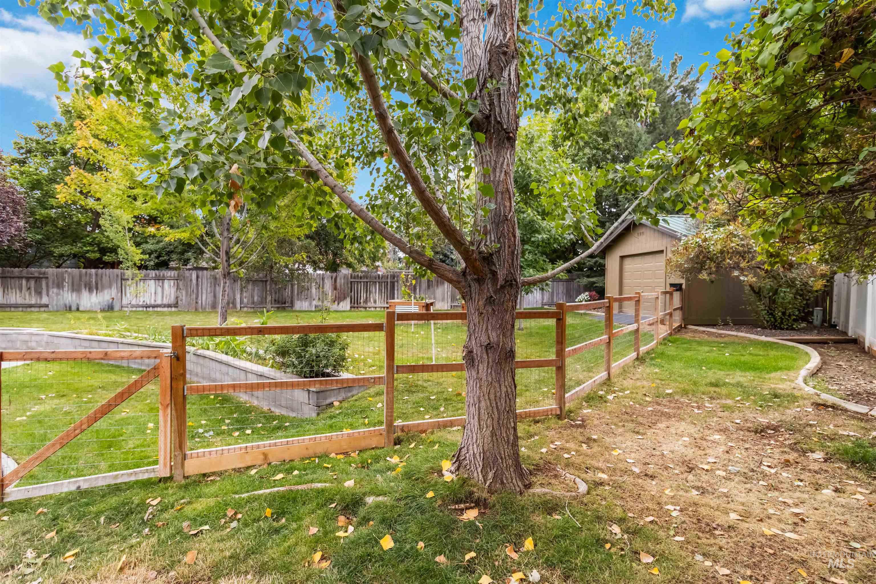 Fenced backyard featuring a garage