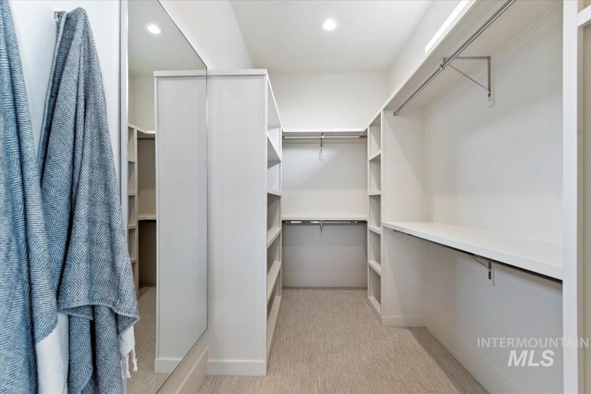 Walk in closet with light carpet