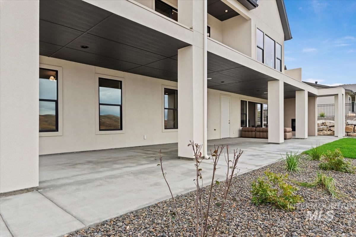 Rear view of house featuring stucco siding and a patio