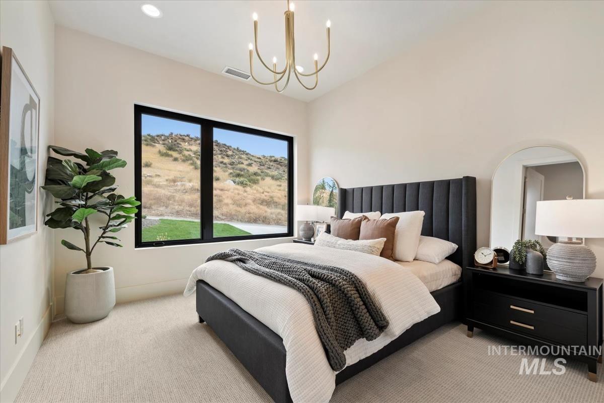Bedroom with carpet, a chandelier, and recessed lighting