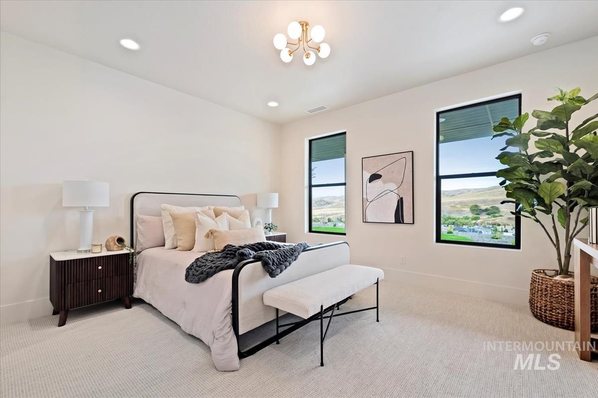Bedroom with carpet floors, recessed lighting, and a chandelier