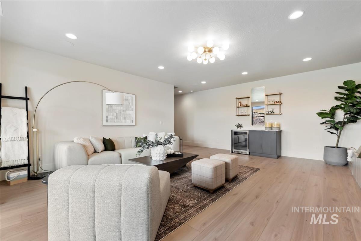 Living area with light wood-type flooring, recessed lighting, and wine cooler