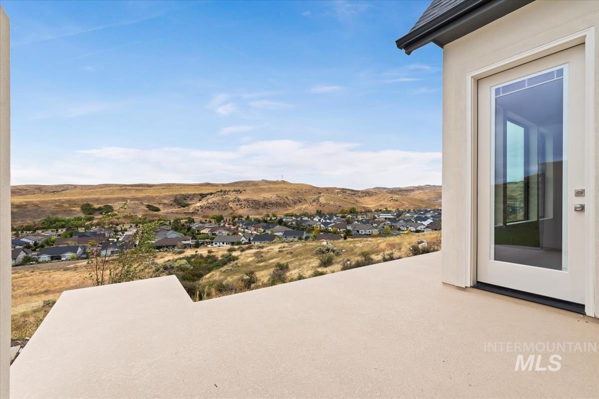 View of patio / terrace featuring a residential view and a mountain view