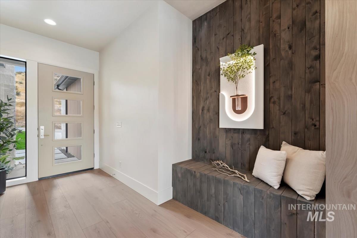Foyer featuring wooden walls and wood finished floors